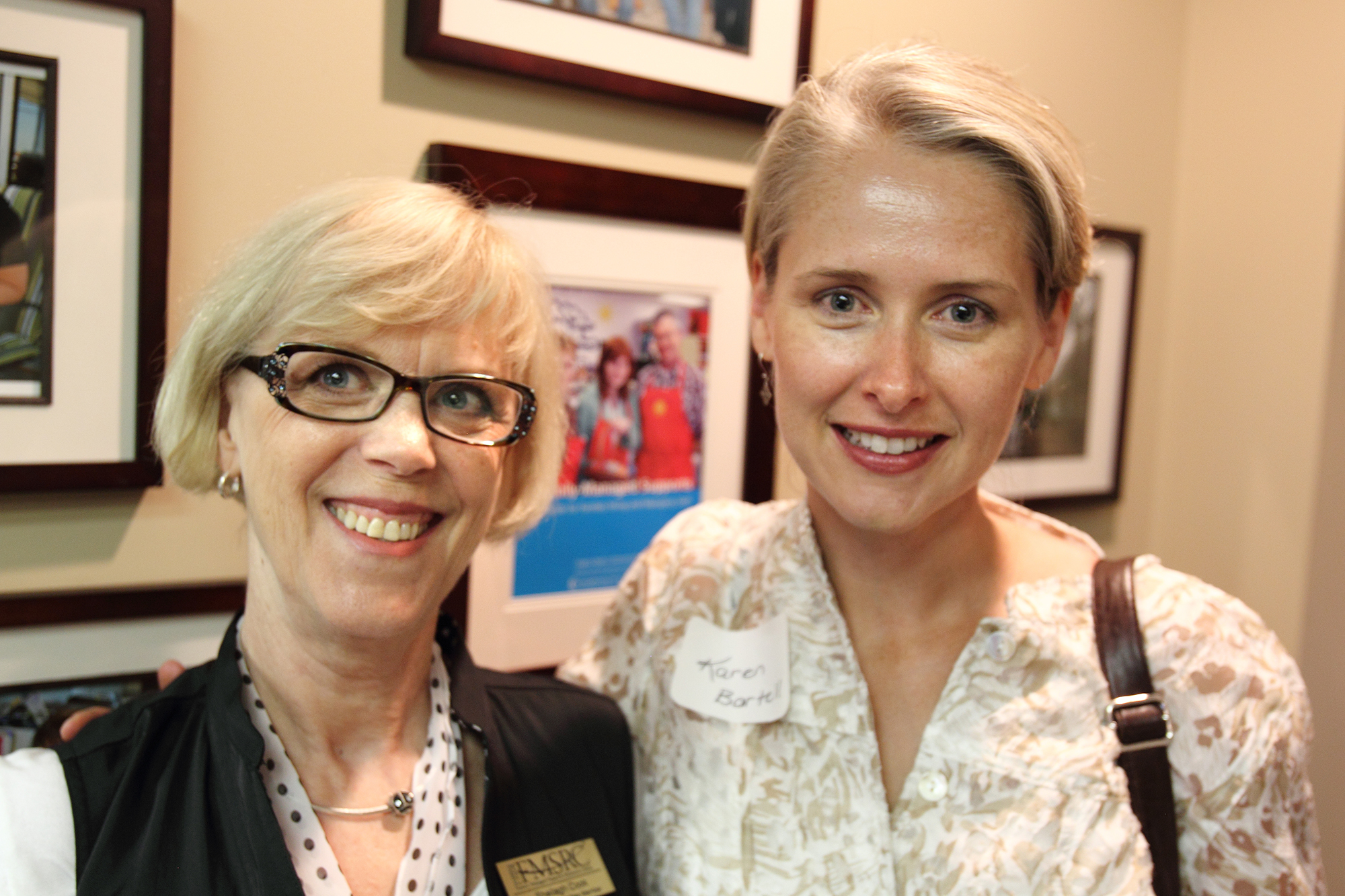 Two women smile as they pose for the camera