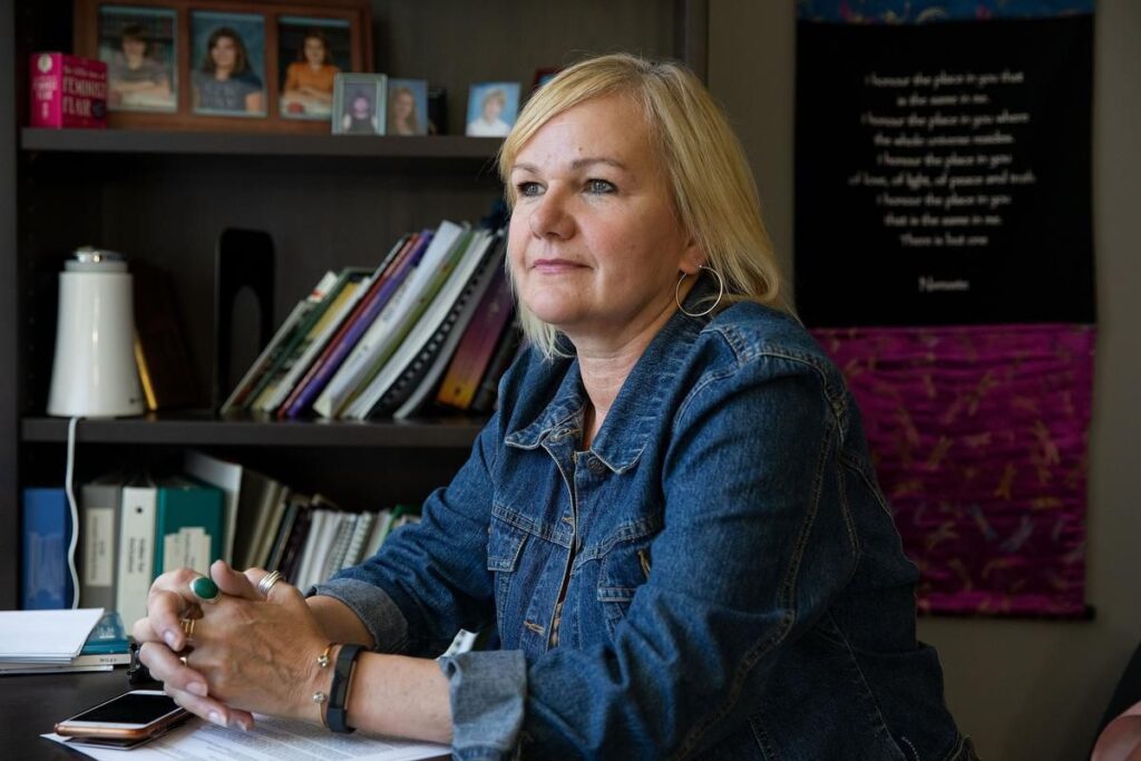 Inclusion Alberta CEO Trish Bowman sitting at desk