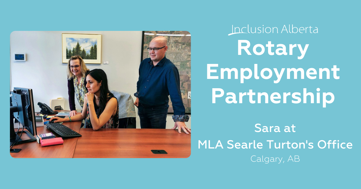 Rotary Employment Partnership. Sara at MLA Searle Turton's Office. Calgary, Alberta. Sara sits at a desk looking at her computer, MLA Turton and another colleague look on from beside her.