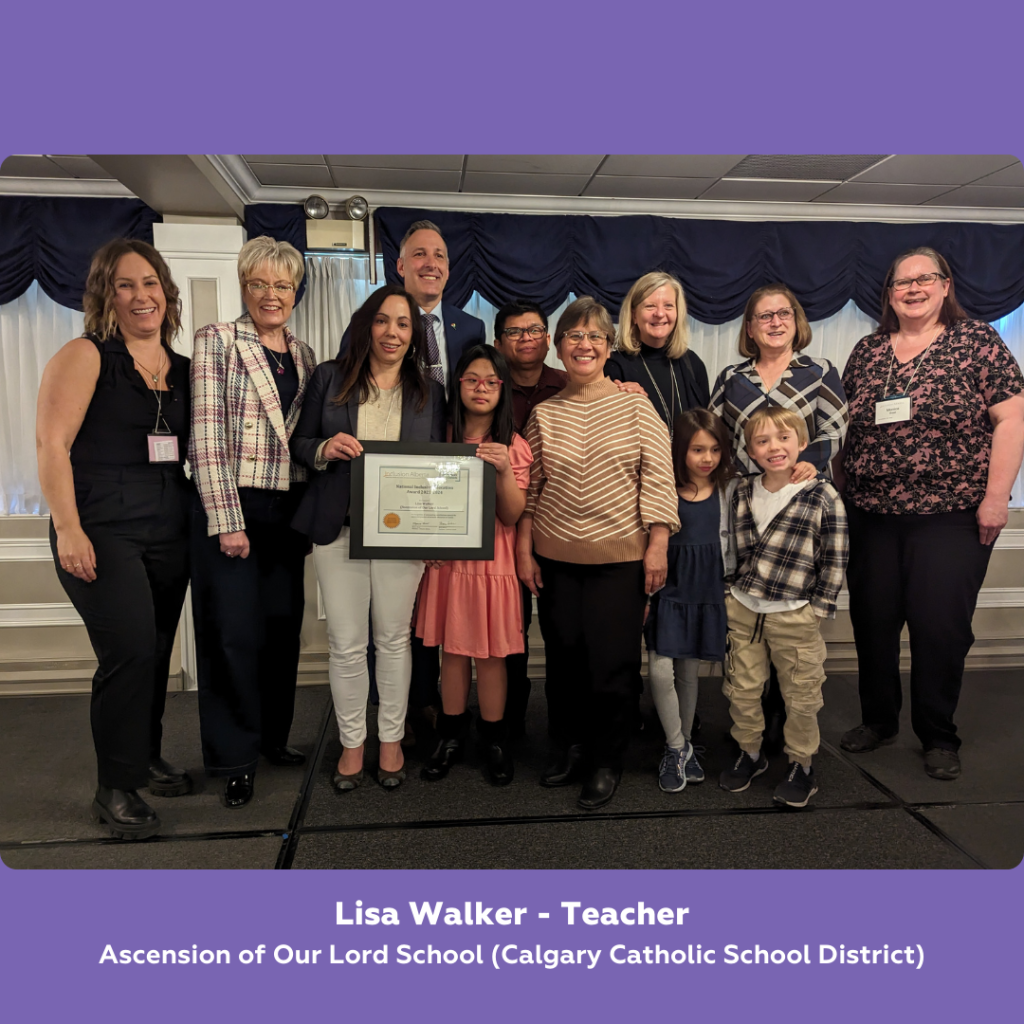 A group photo of 12 people standing on stage posing, one person is holding a framed certificate. Below it text reads: Lisa Walker - Teacher. Ascension of Our Lord School (Calgary Catholic School District)